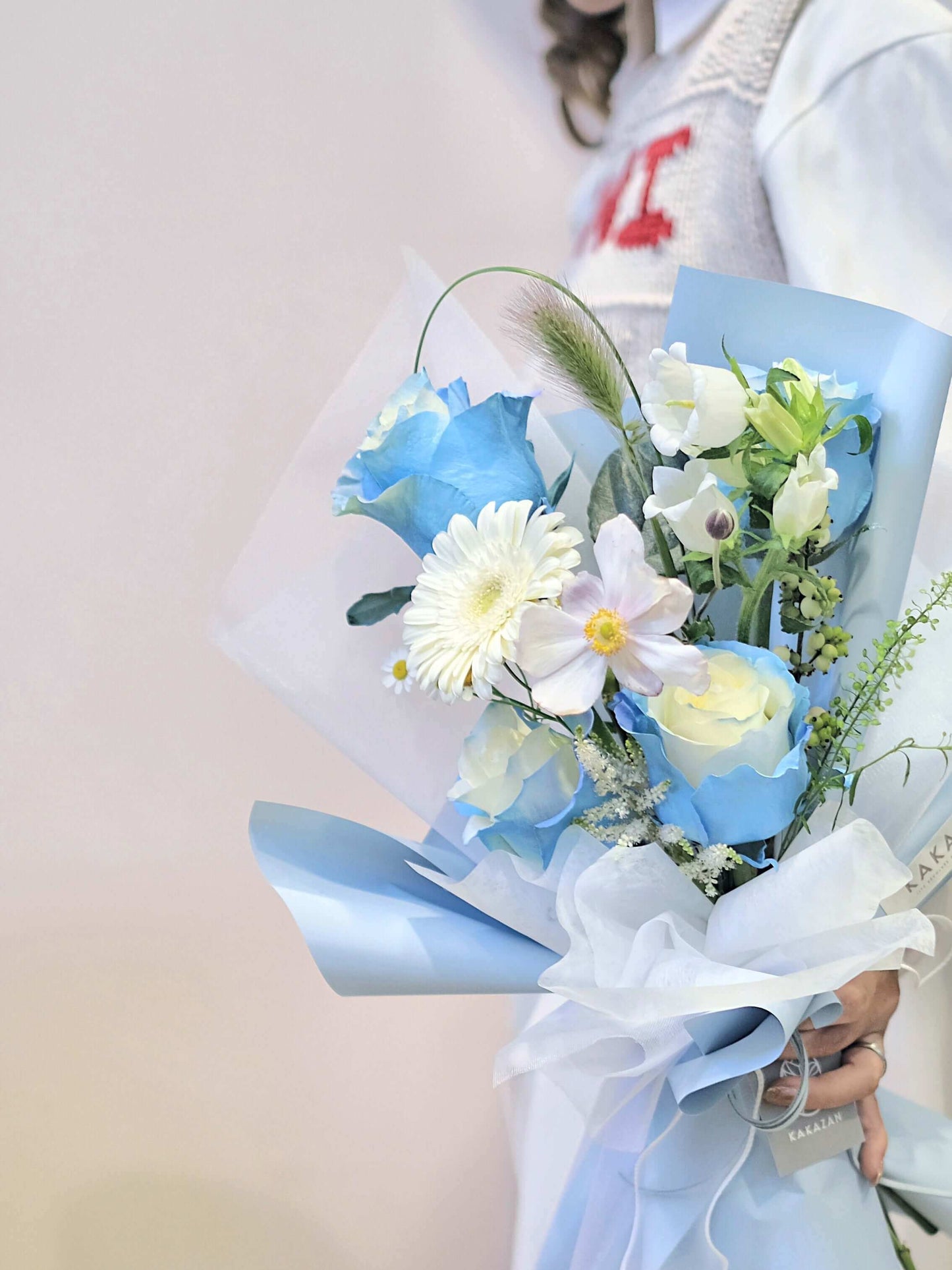 Holding White and Blue tone flower bouquet